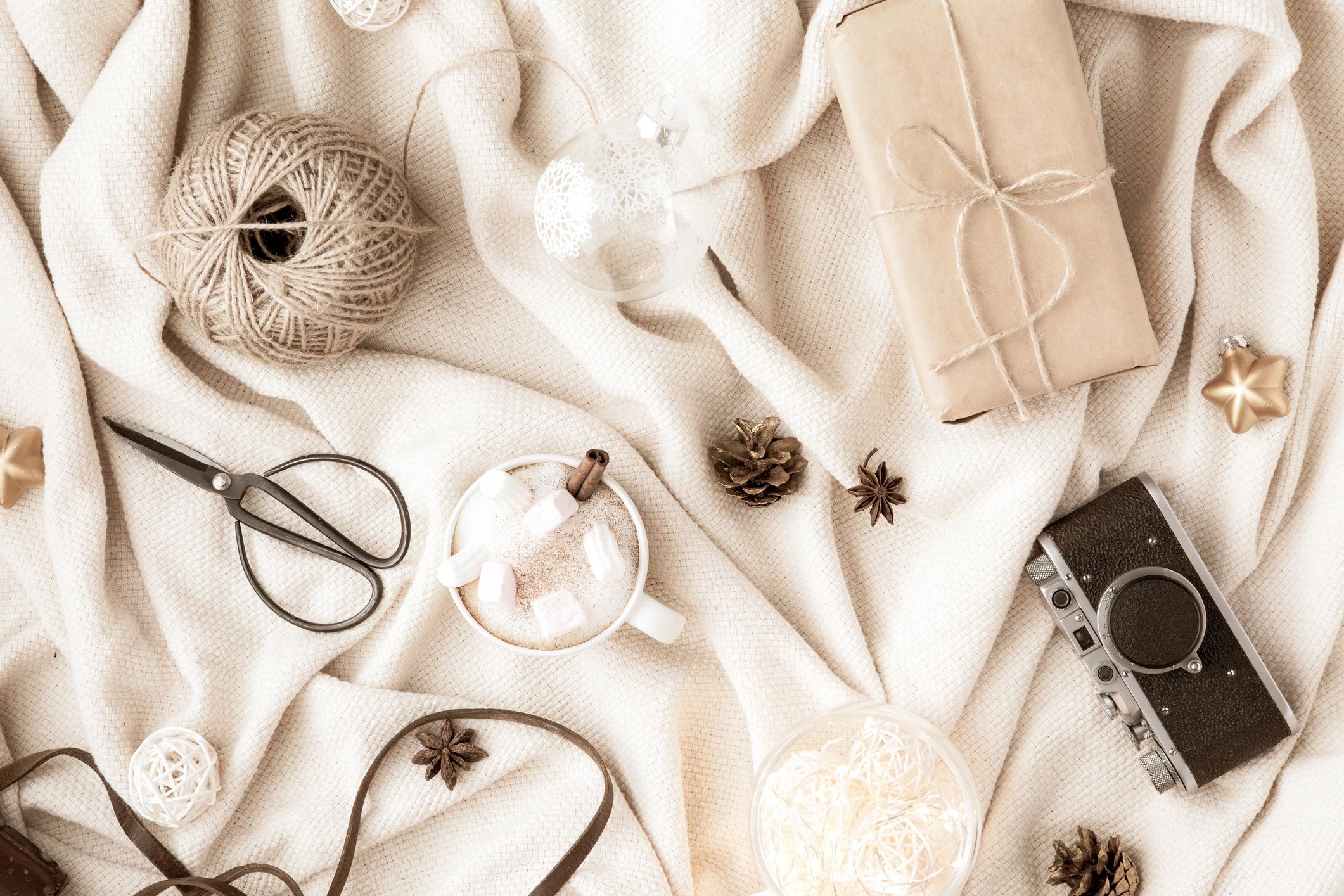 Neutral flat lay with soft textiles and warm tones
