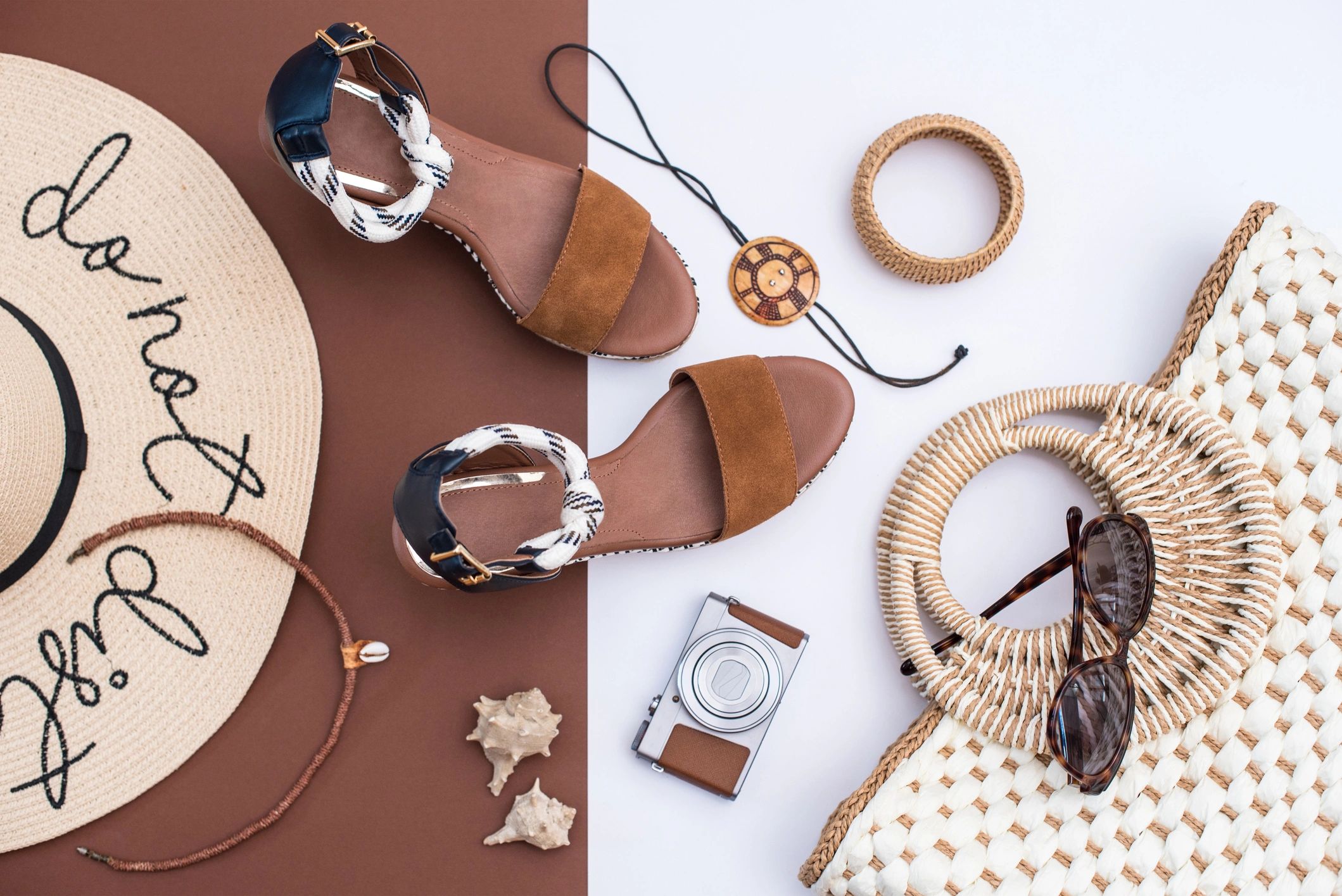 Neutral accessories flat lay in white and brown tones