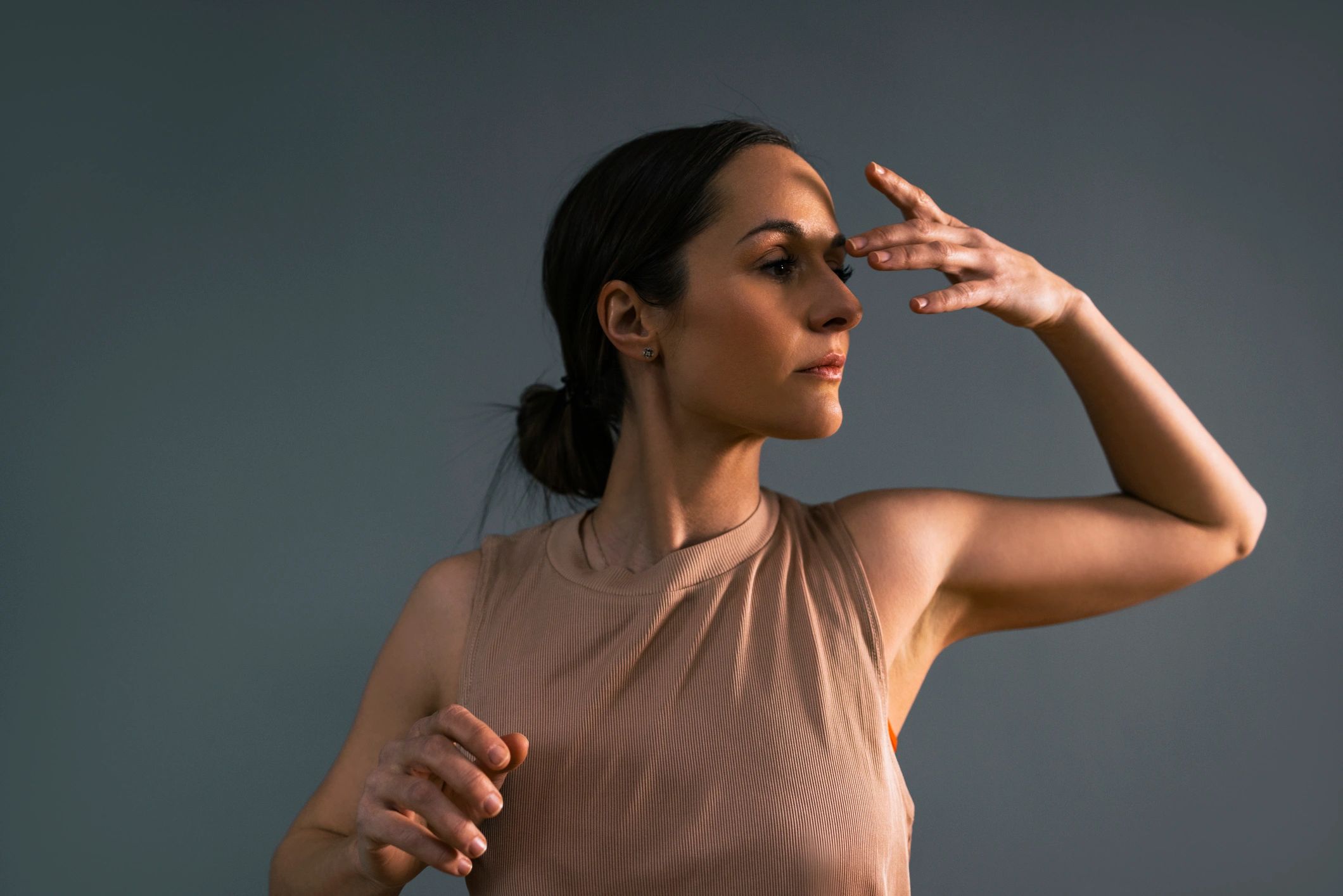 Woman moving in minimal studio setting