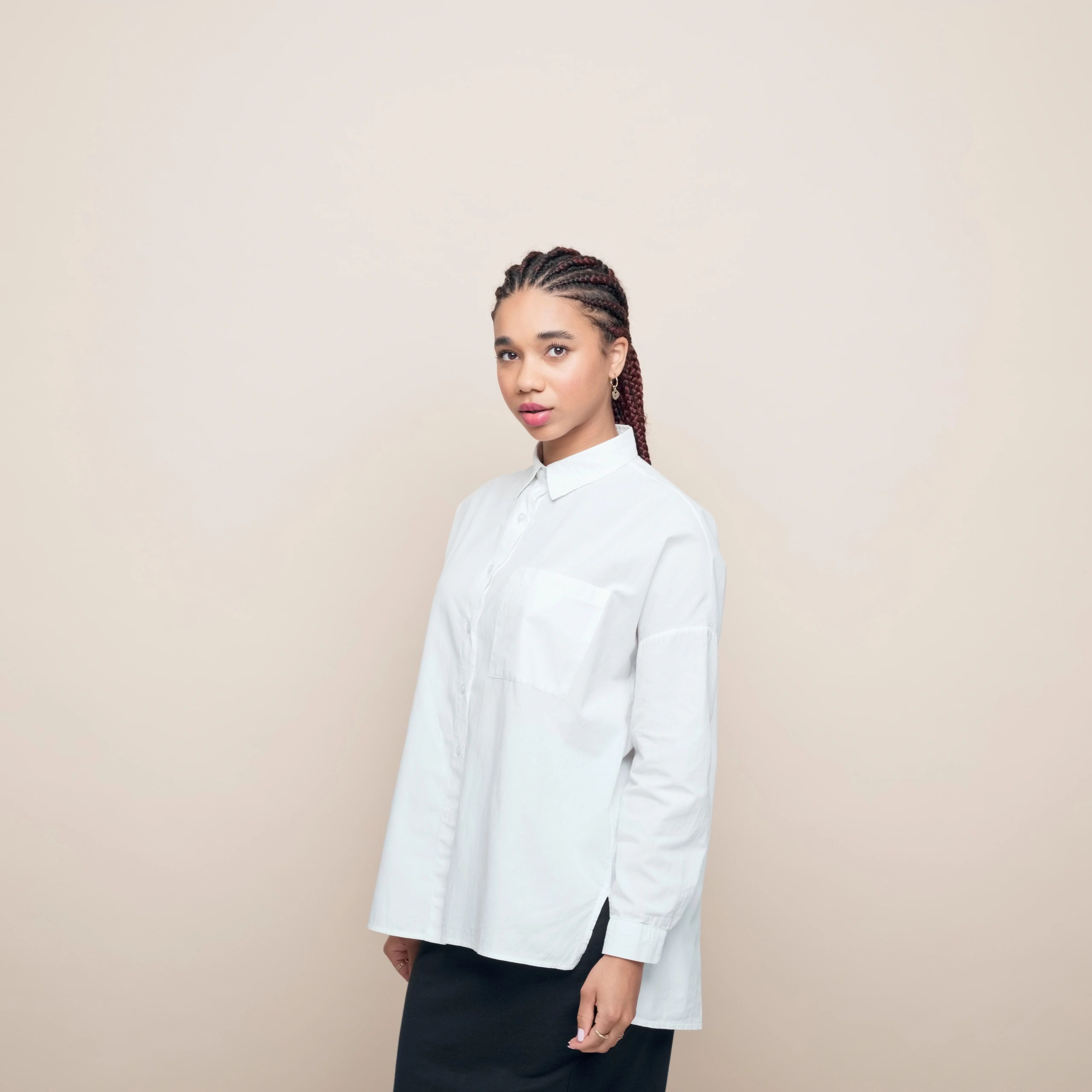 Soft-light studio portrait of a woman against a neutral background, minimal editorial style