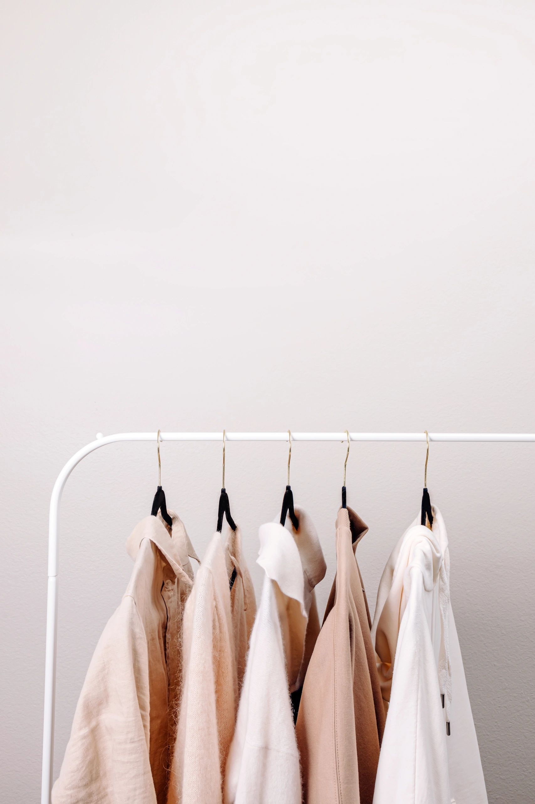 Minimal wardrobe with clothing on a rack