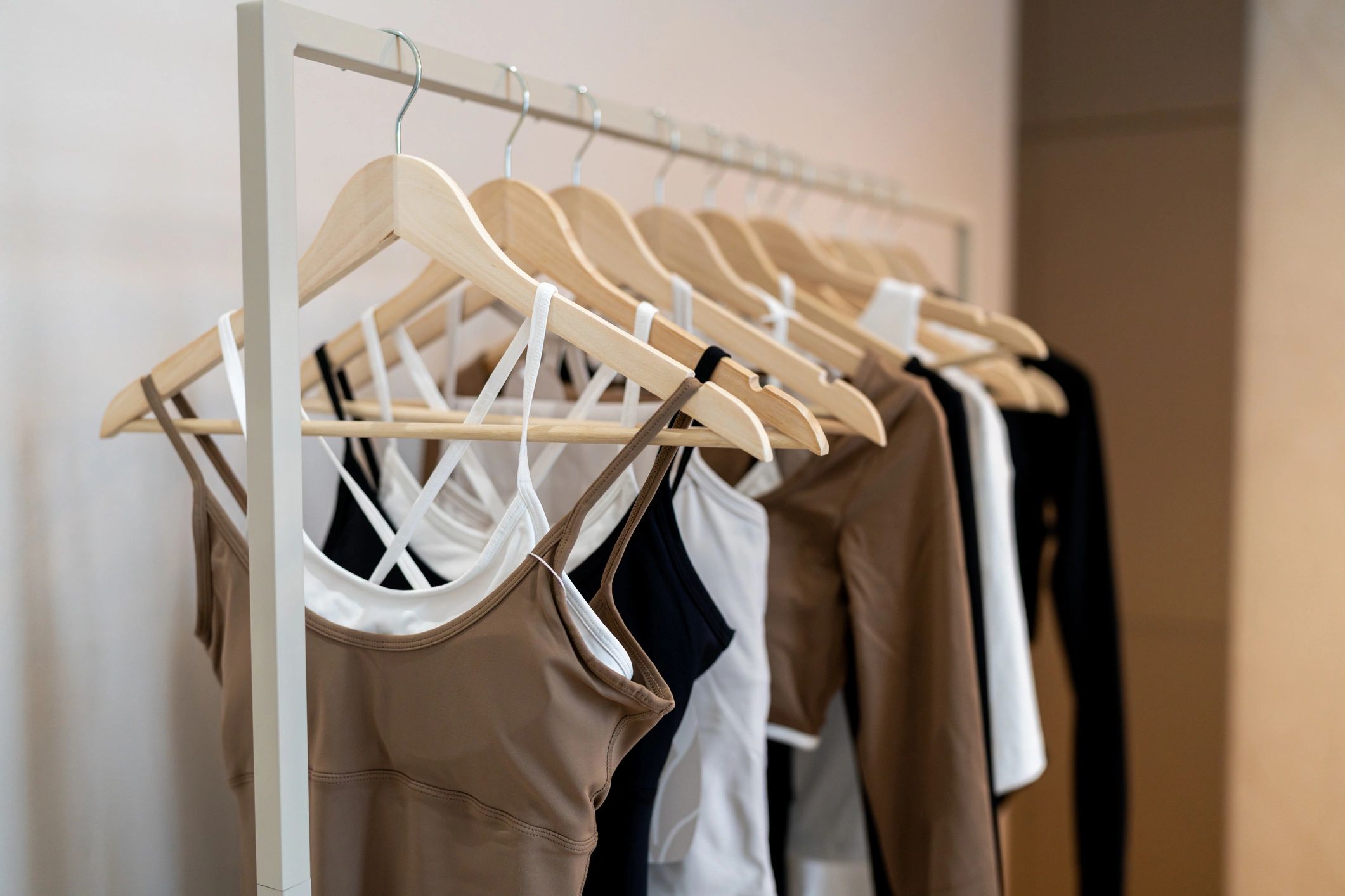 Organized clothing on hangers on a rack